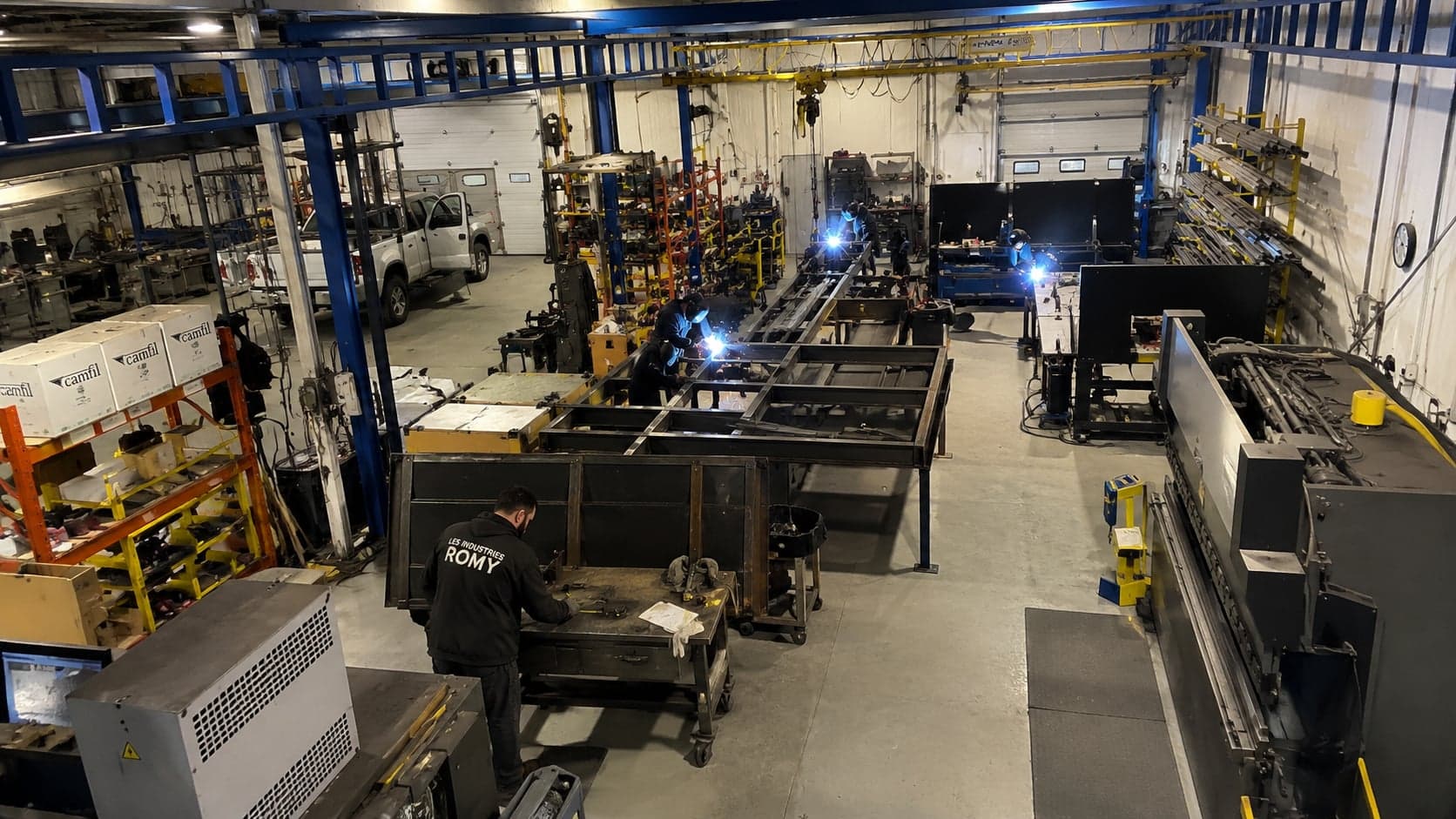 Les soudeurs des Industries Romy assemblent une structure d’acier dans l’atelier de Granby